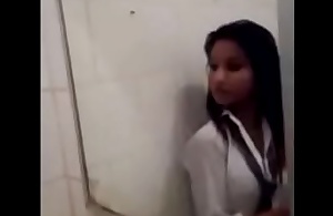 Indian girl archana doing identity card beside bathroom