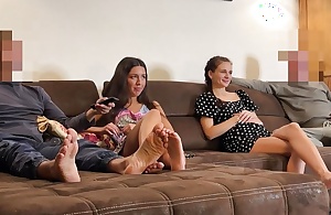 Four married couples watch small screen and thing embrace
